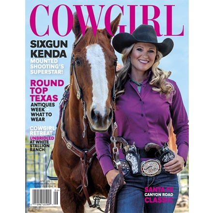 Cowgirl magazine cover. Woman with cowboy hat and revolvers next to horse.
