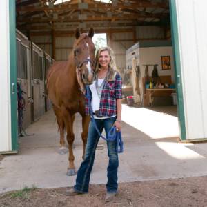 Devon with horse in front of open barn door